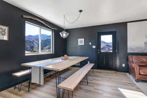 Dining room with light wood-style flooring, healthy amount of natural light, and breakfast area