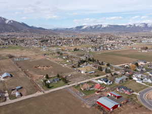 Aerial overview of property's location with a mountainous background and rural landscape