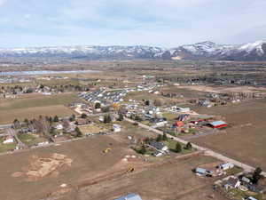 Aerial view of property and surrounding area with a water and mountain view and rural landscape