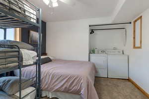 Bedroom with washer and dryer and ceiling fan