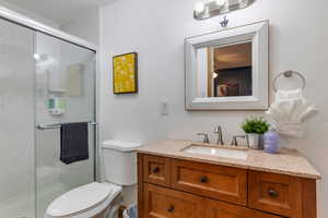 Bathroom with a shower stall and vanity