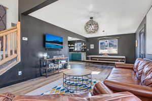 Living area with wood finished floors and stairs