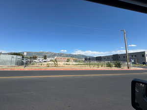 View of asphalt road featuring curbs