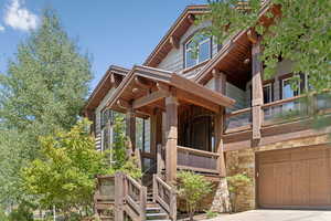 Entrance to property featuring stone siding