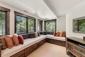 Living area featuring light carpet and recessed lighting