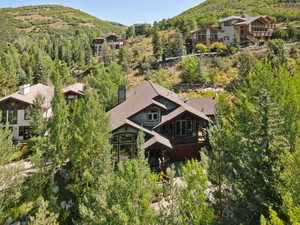 Aerial view of property and surrounding area with a mountain backdrop