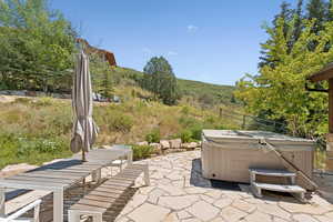 View of patio featuring a hot tub