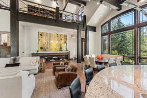 Common area featuring high vaulted ceiling, stairway, and beamed ceiling