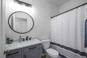 Full bath with vanity and a shower with shower curtain