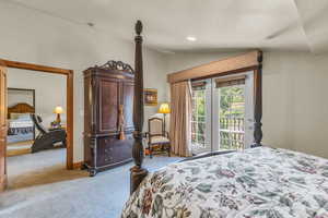 Bedroom with lofted ceiling, access to outside, light colored carpet, and recessed lighting