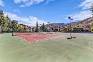 View of tennis court featuring a mountain view