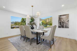 Dining area with a mountain view, recessed lighting, and light wood-style floors