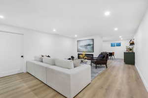 Living room with recessed lighting and light wood-style floors