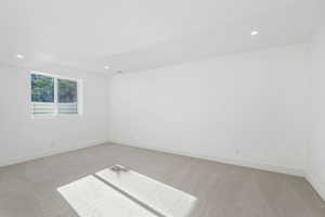 Spare room featuring light carpet and recessed lighting