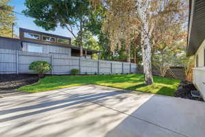 Fenced backyard with a patio area