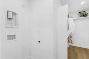 Washroom with wood finished floors, washer hookup, electric dryer hookup, and recessed lighting