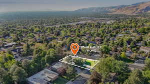 Aerial perspective of suburban area featuring property parcel outlined and mountains