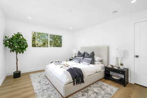 Bedroom with light wood-style flooring and recessed lighting