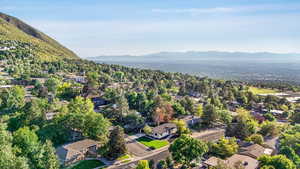 Aerial overview of property's location featuring nearby suburban area and mountains