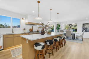 Kitchen with light wood-style flooring, pendant lighting, recessed lighting, and plenty of natural light