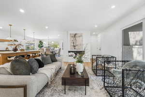 Living room featuring light wood finished floors and recessed lighting