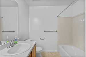 Full bathroom featuring vanity, shower / tub combination, and light tile patterned flooring