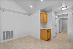 Interior space featuring vaulted ceiling and recessed lighting