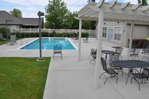 Community pool with a patio and a pergola
