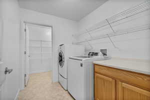 Laundry area featuring independent washer and dryer and baseboards
