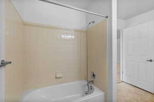 Bathroom with shower / bath combination and tile patterned flooring
