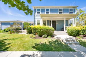 View of front of house featuring a porch and a front yard