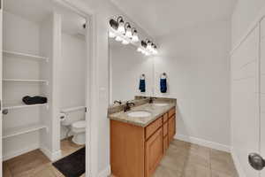 Full bath with light tile patterned flooring and a textured ceiling