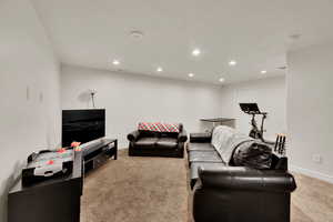 Living area featuring light carpet and recessed lighting