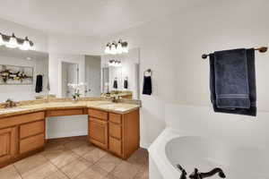 Bathroom featuring a garden tub and light tile patterned flooring