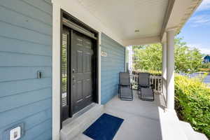 View of exterior entry with covered porch