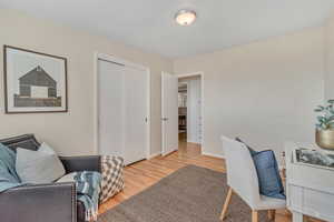 Office space with light wood-style floors and baseboards