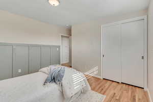 Bedroom featuring light wood-style floors and a closet