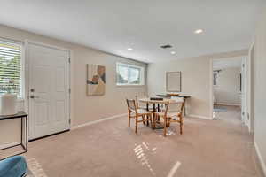 Dining area featuring light carpet and recessed lighting