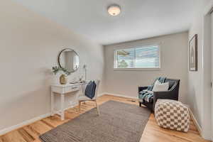 Home office with baseboards and light wood finished floors