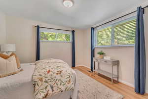Bedroom with light wood-style floors and baseboards