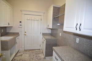 Kitchen with white cabinets and backsplash