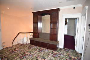 Hall with a textured ceiling, carpet, recessed lighting, and an upstairs landing