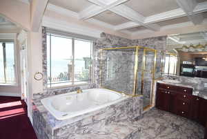 Full bath with a water view, vanity, a whirlpool tub, a shower stall, and ornamental molding