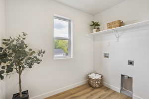 Laundry room with light wood finished floors, washer hookup, and hookup for an electric dryer