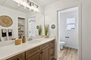 Full bath featuring light wood-style flooring and vanity