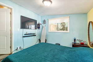 Bedroom with a textured ceiling
