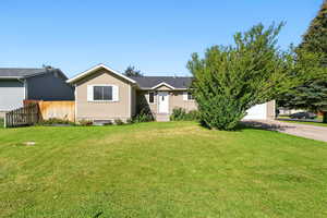 View of front of house with concrete driveway and a garage