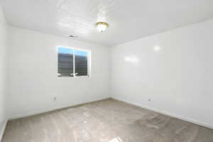 Unfurnished room with light carpet and baseboards