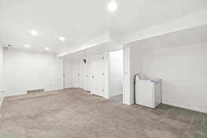 Finished basement featuring washer / clothes dryer, carpet, and recessed lighting