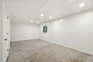 Spare room with light carpet and recessed lighting